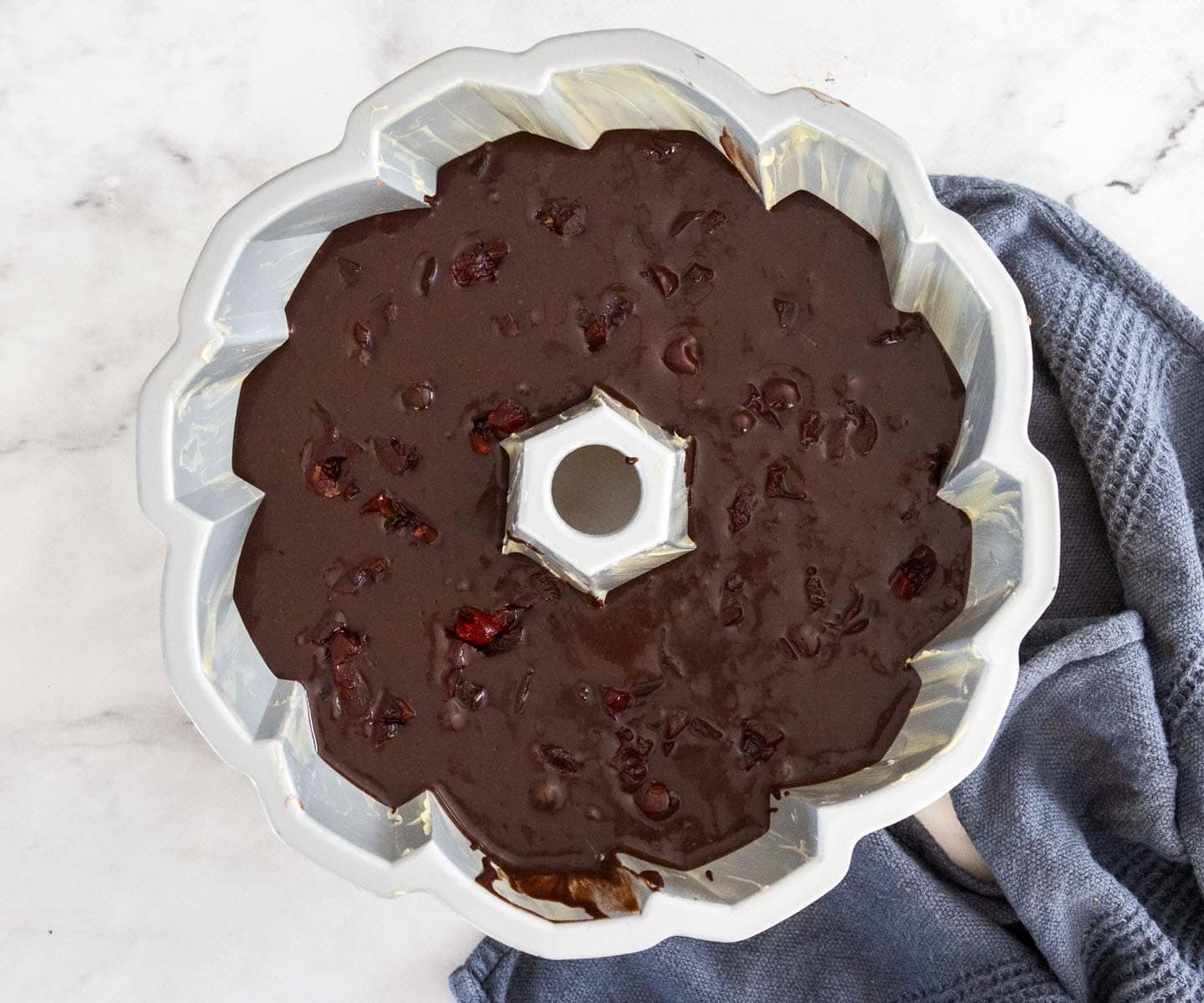 Cherry Chocolate Bundt Cake The cake batter with cherries in the bundt pan.