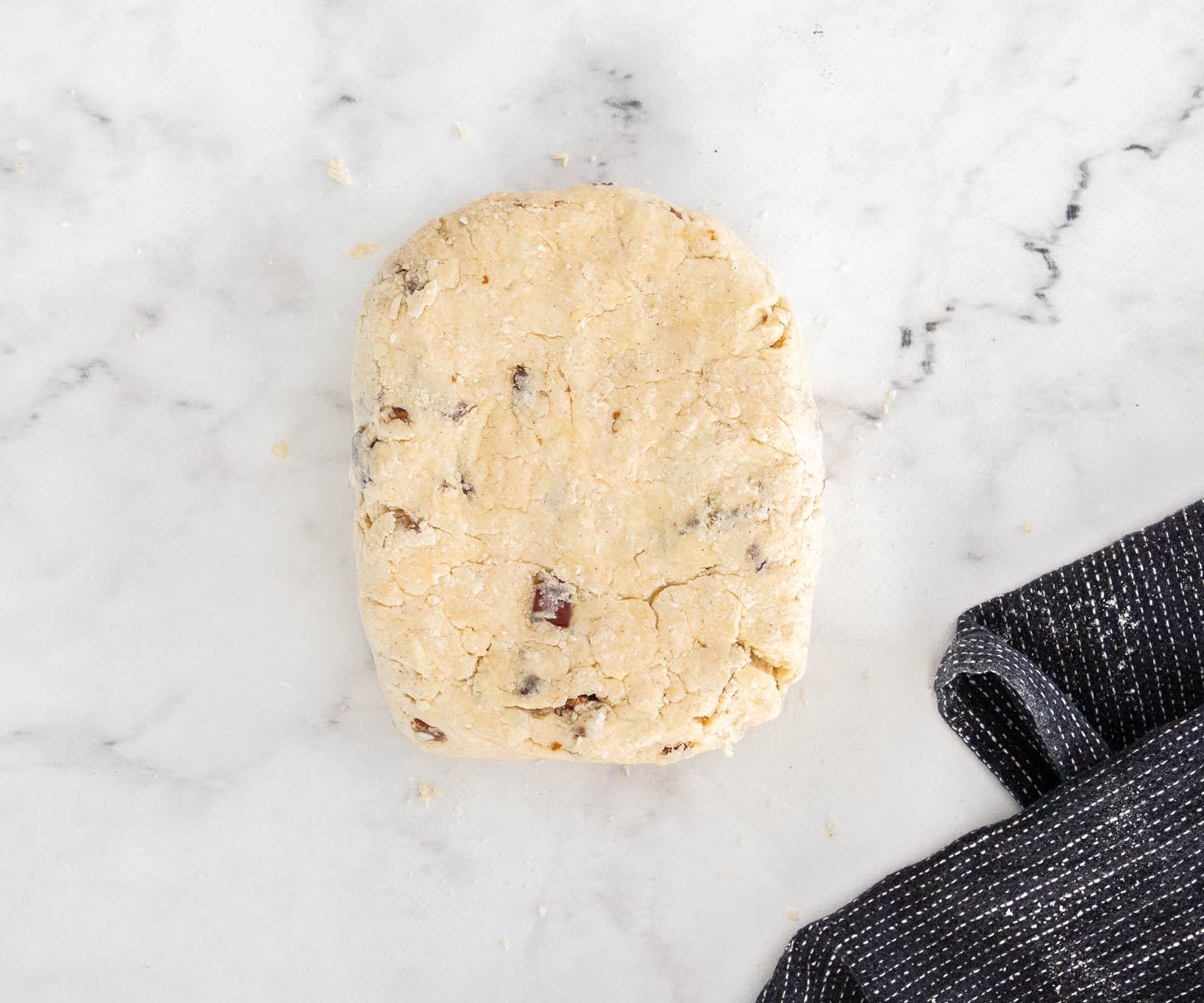 Date Scones The date scone dough on a marble surface.
