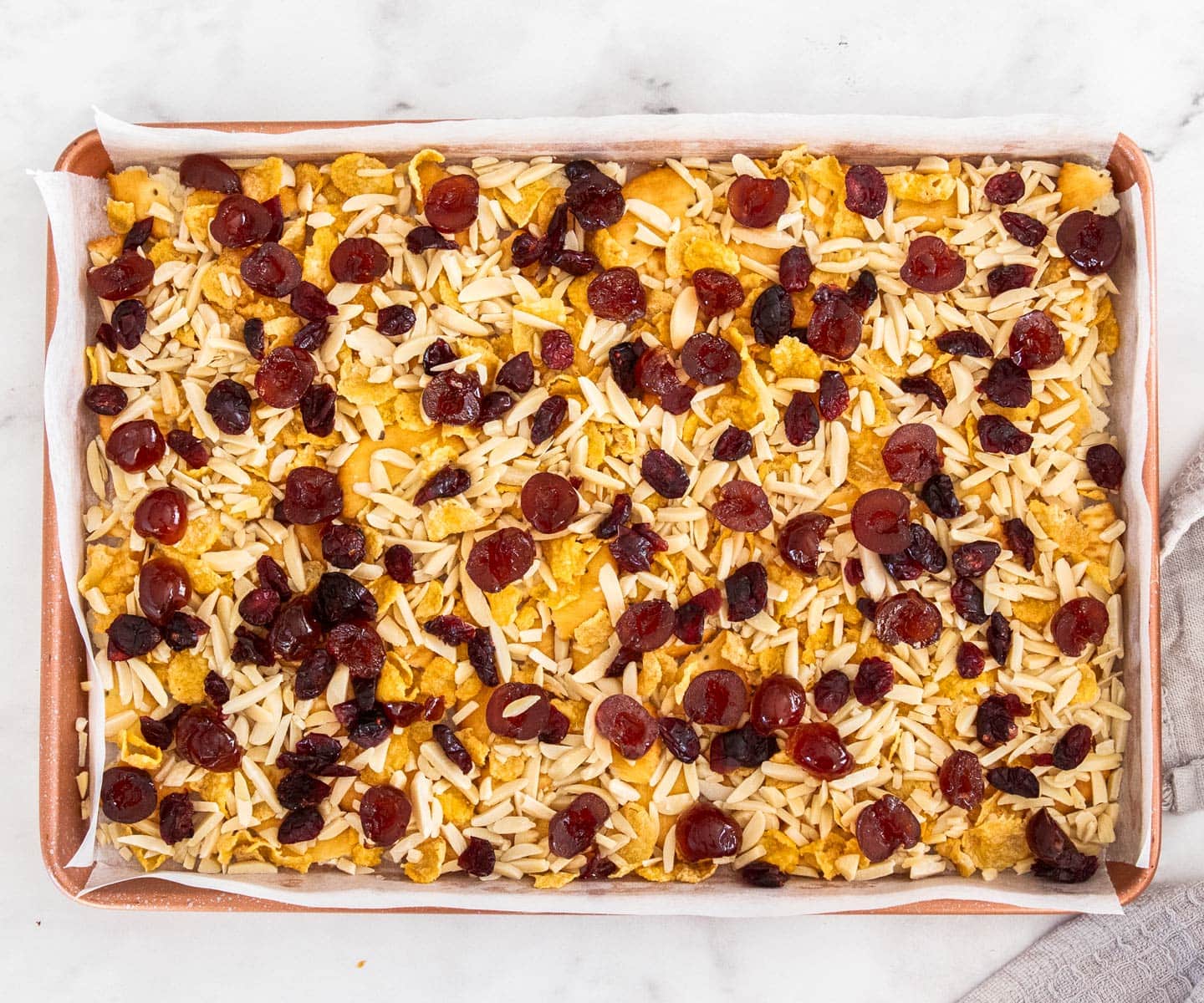 The other filling ingredients scattered over the crackers in the baking tray.