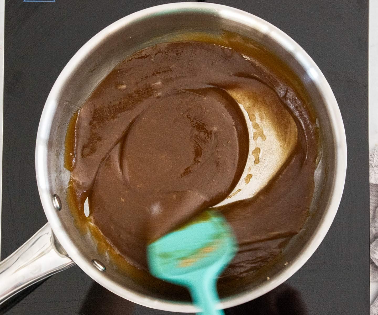 The sugar and butter stirred together in a pan.