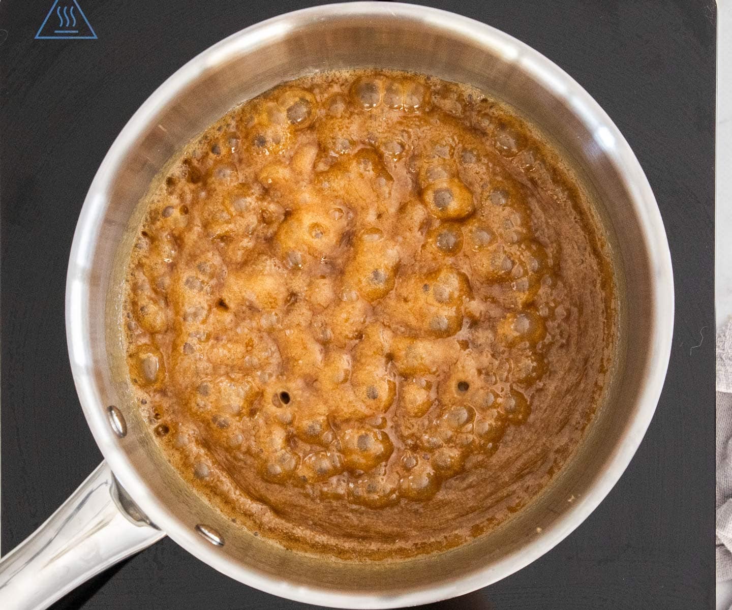 The toffee mixture bubbling in a pan.