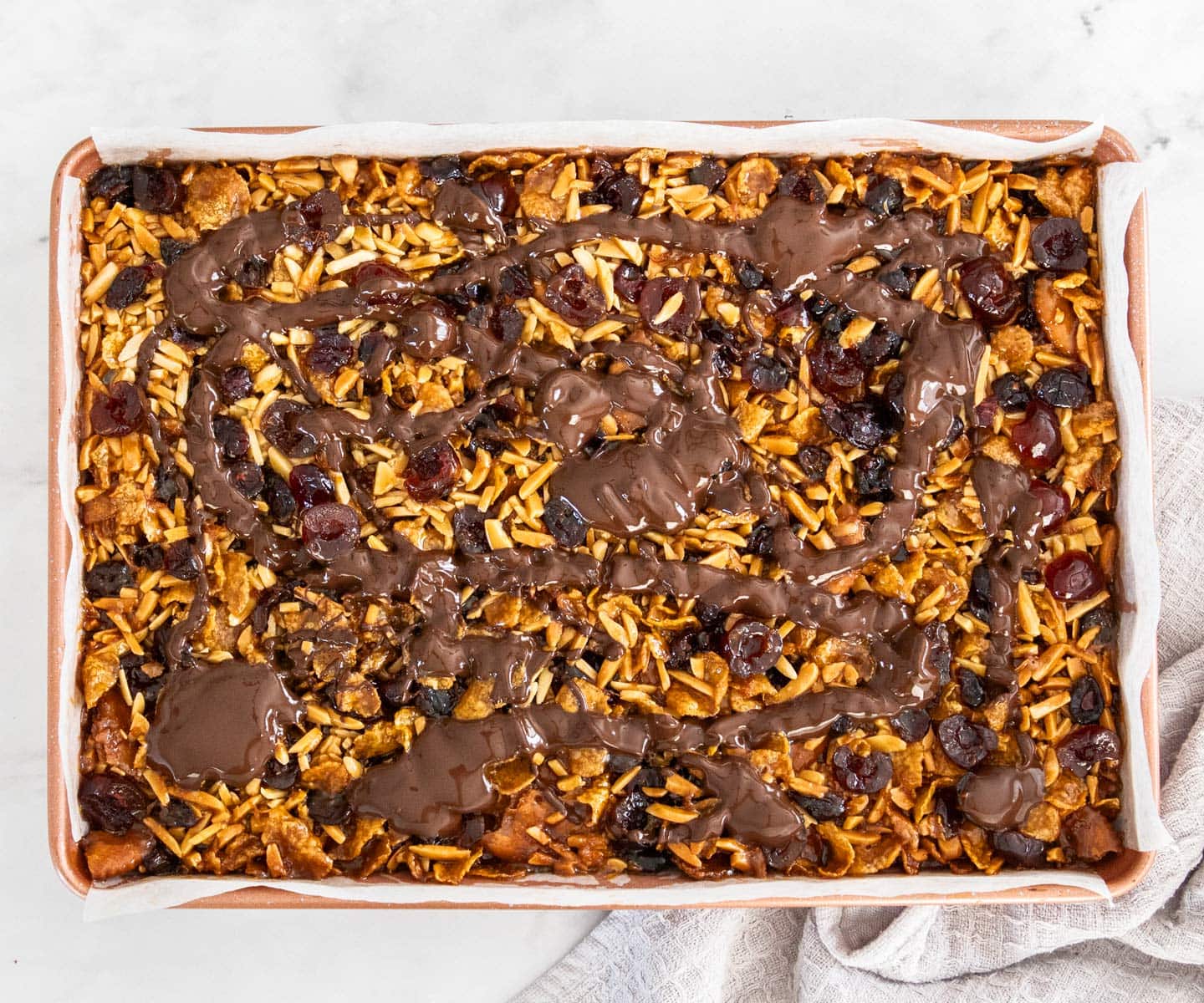 The melted chocolate drizzled over the florentine slice.