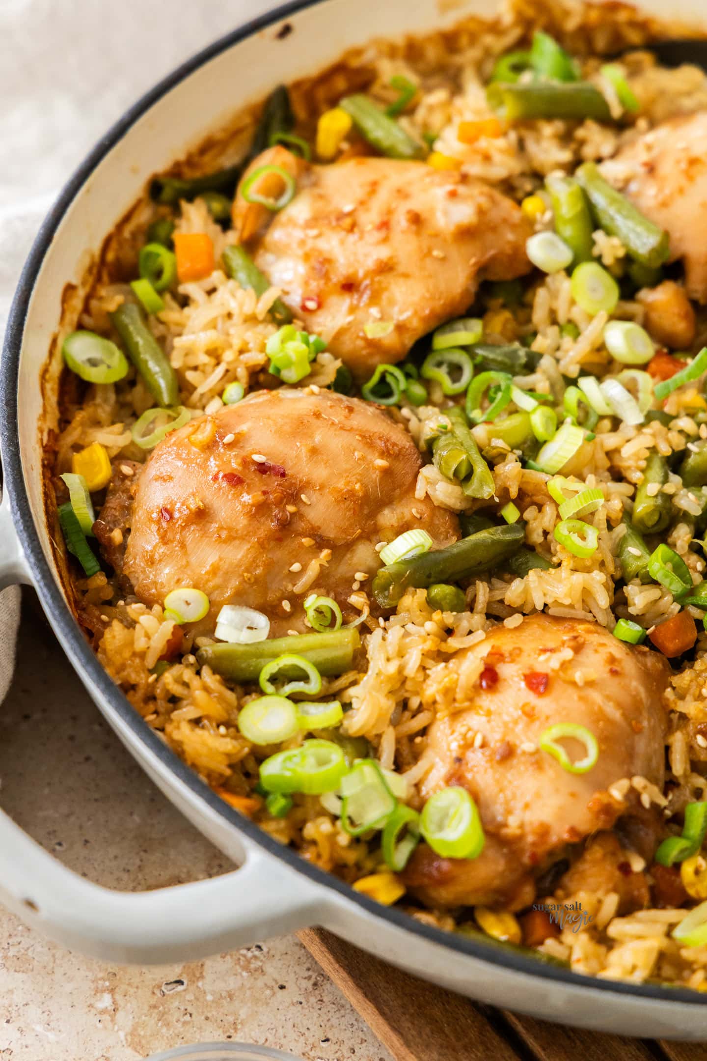 One Pan Baked Chicken and Rice Angled view into the pan showing the baked chicken and rice.
