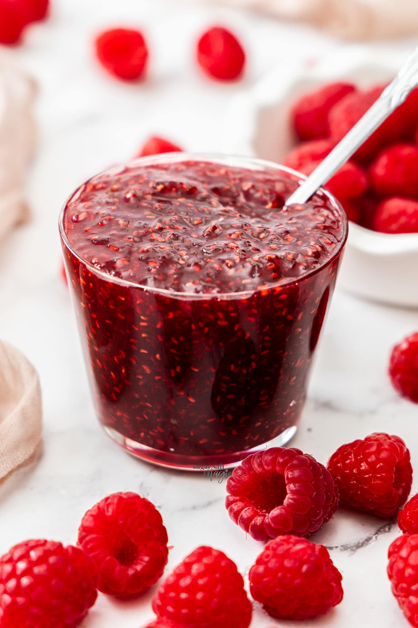 Easy Raspberry Jam A glass full of raspberry jam.