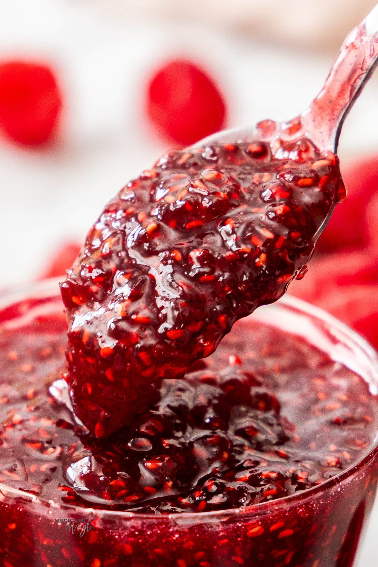 Easy Raspberry Jam Extreme closeup of a spoonful of raspberry jam.