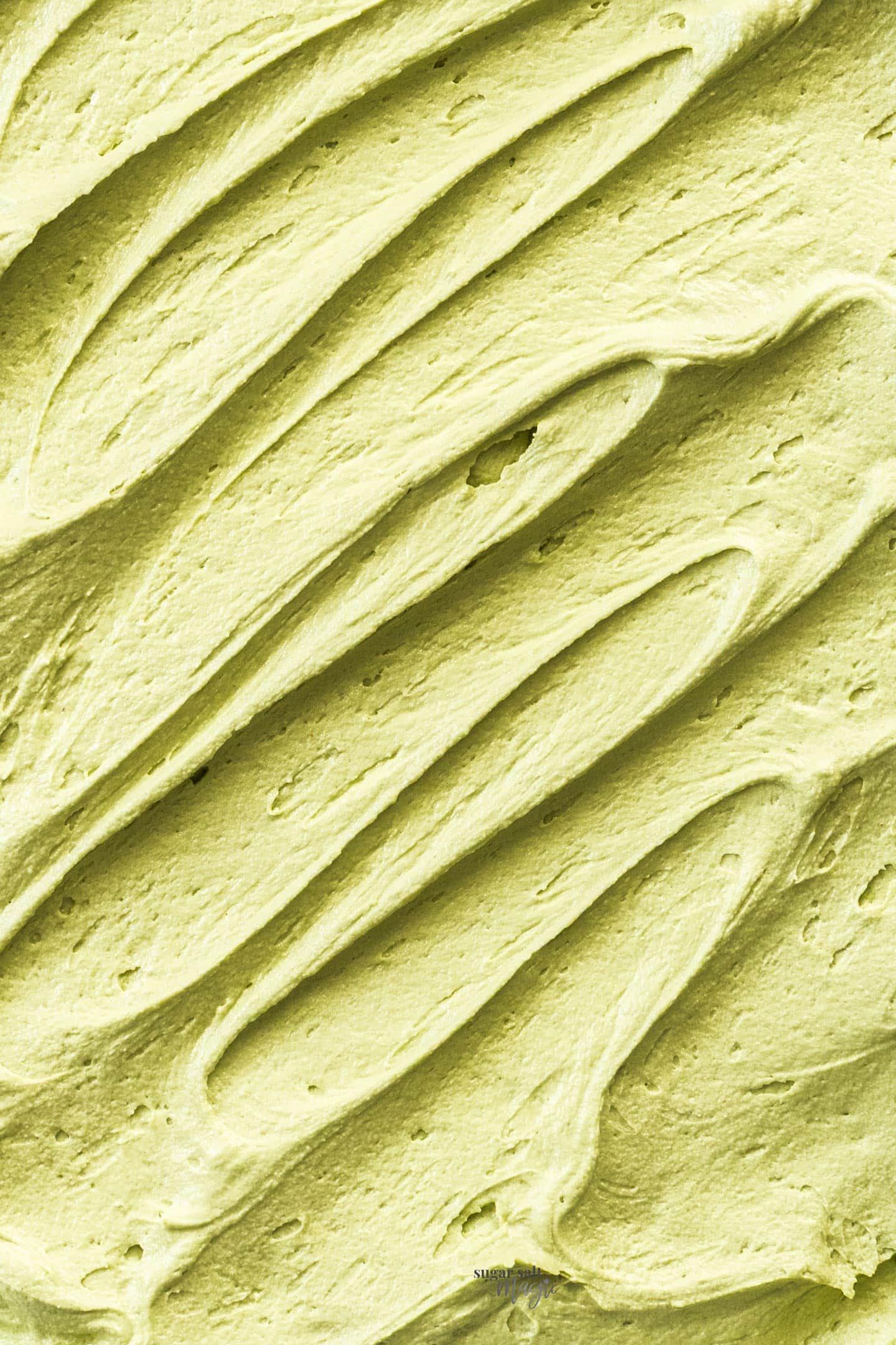 Pistachio Buttercream Extreme closeup of swirls in pistachio buttercream.