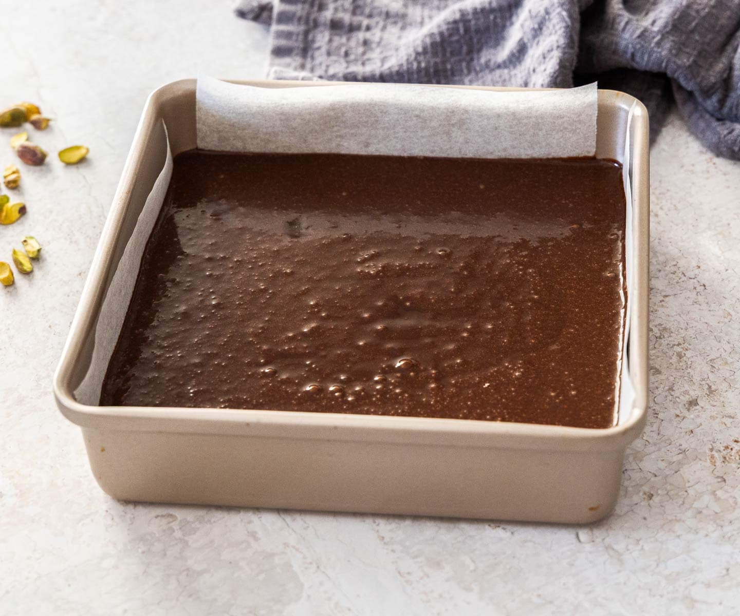 Pistachio Chocolate Snack Cake The chocolate cake batter in a square pan.