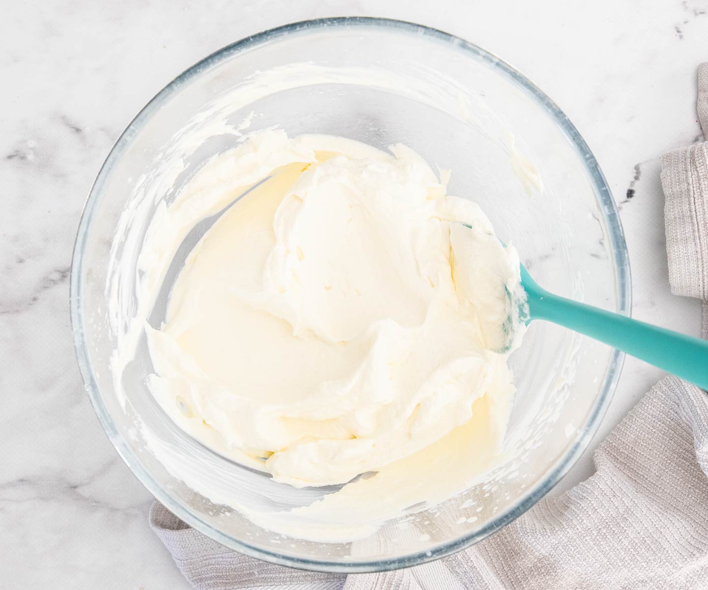 Raspberry Sponge Cake Cream whipped in a mixing bowl.
