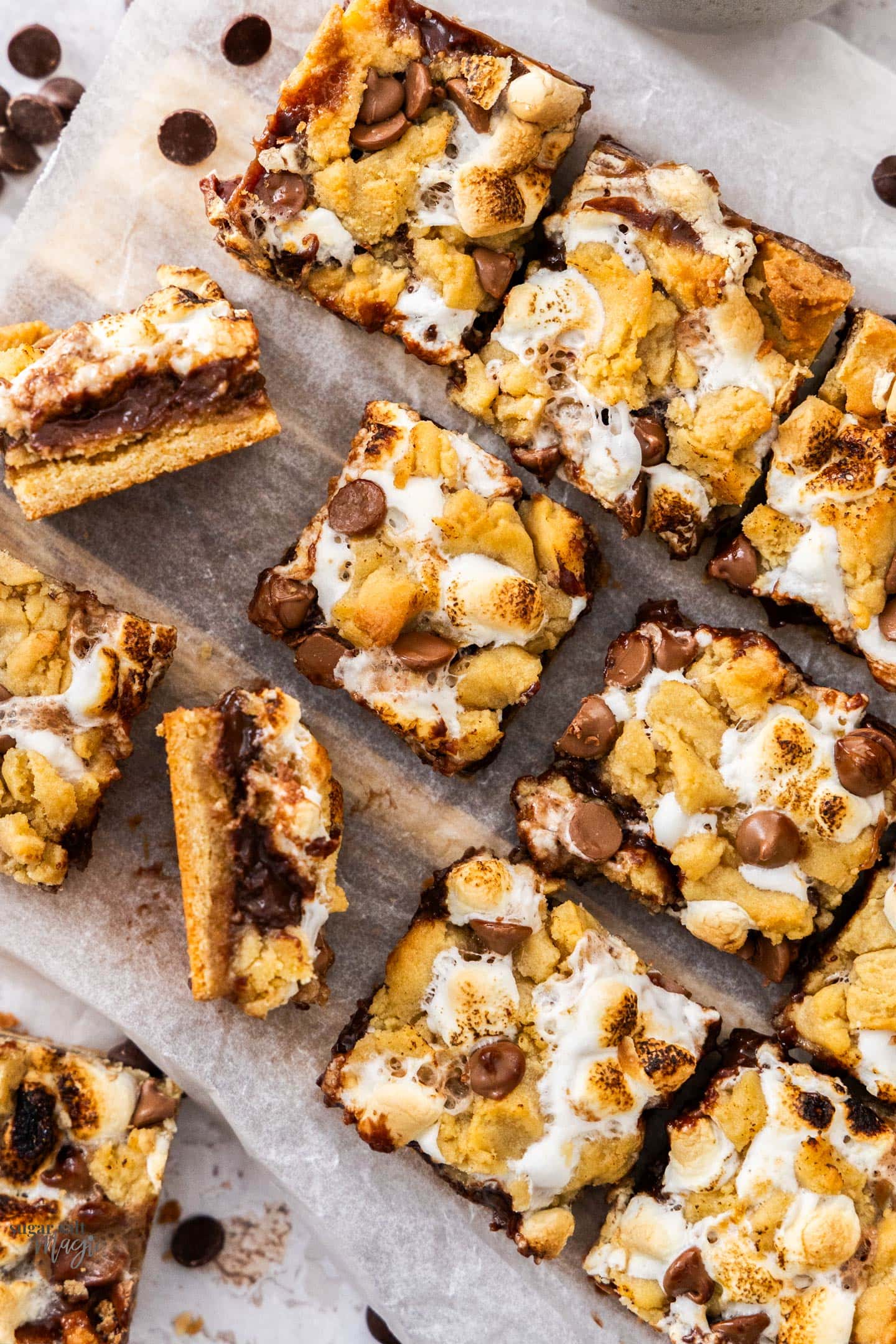 S'mores Cookie Bars Top down view of s'mores cookie bars on a wooden platter.