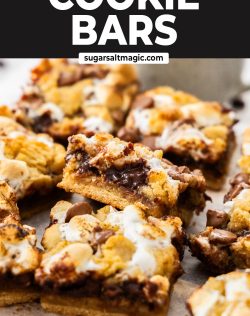 A s'mores cookie bar leaning up against another showing the gooey chocolate centre.
