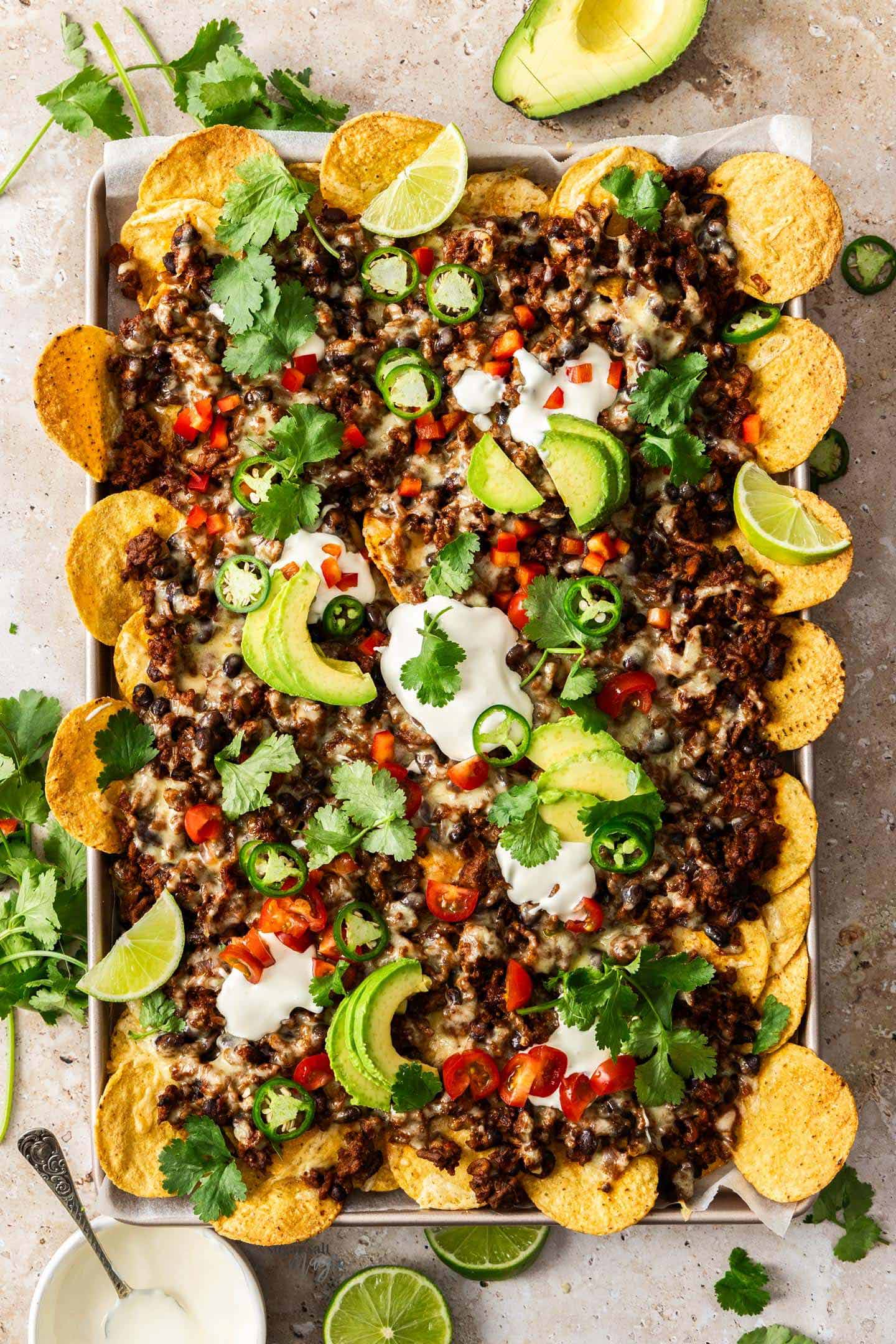 Halal ground beef nachos with seasoned beef cheese jalapeños and all toppings baked golden for crowd-pleasing budget dinner