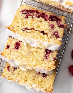 Top down view of 3 slices of coconut raspberry cake on a wire rack.