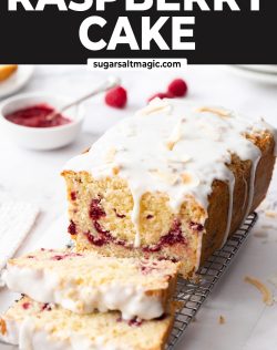 A raspberry coconut loaf cake on a wire rack with 2 slices cut away.