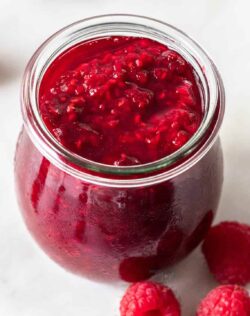 Closeup of a jar of raspberry compote.
