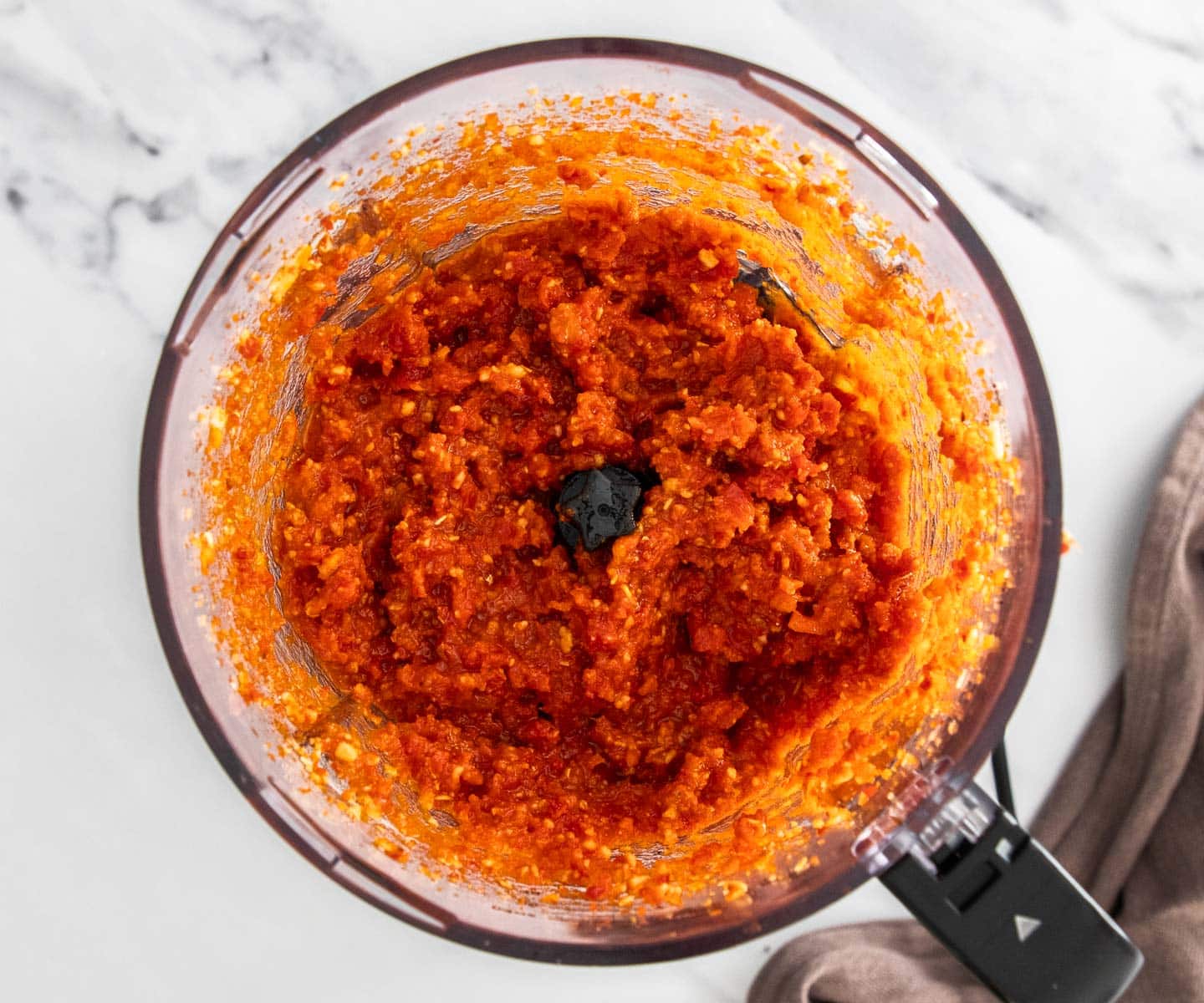 Sun-dried Tomato Pesto Pasta The tomato pesto in a food processor bowl.